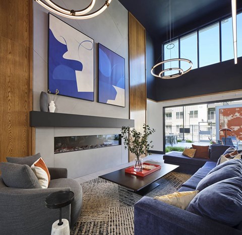 a living room with blue furniture and a fireplace